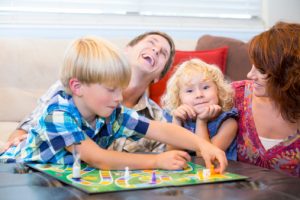 Family with two kids having fun playing board games